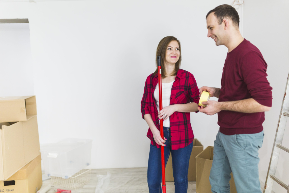 couple-with-renovation-tools-looking-each-other